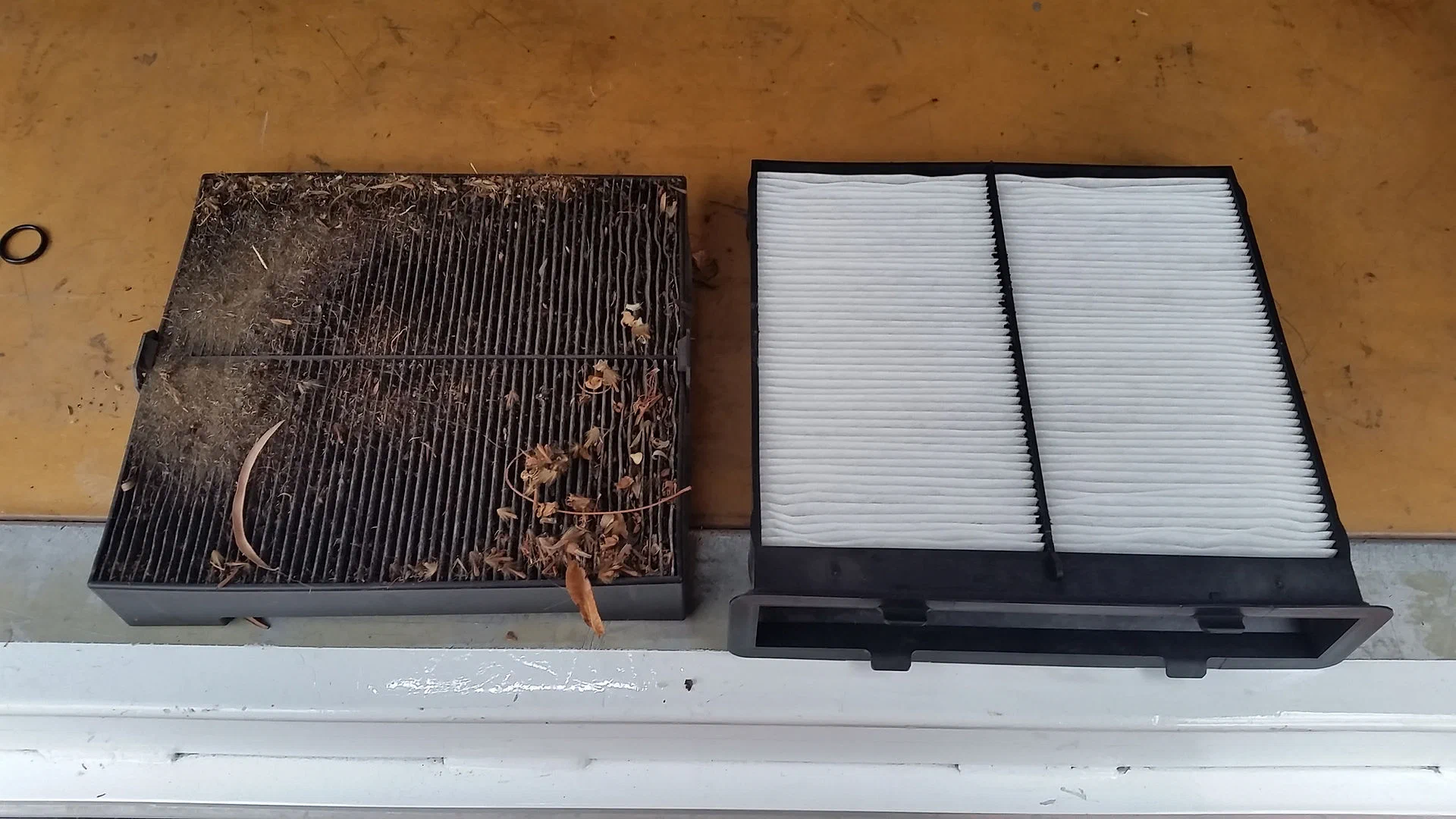 Dirty cabin air filter beside a clean replacement filter | atmechanical | Perth